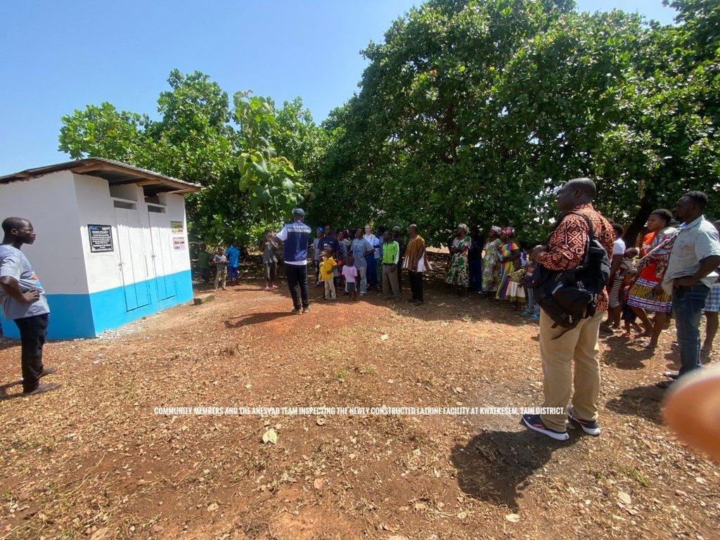 Community support group members in a meeting discussing WASH initiatives